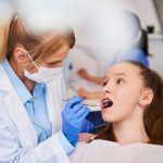 a girl is gettingdental treatment