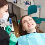 a woman is getting dental treatment.
